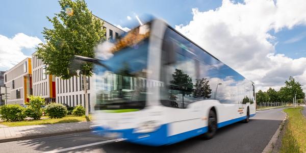Bus fährt auf Straße an Betrachter vorbei